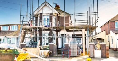 house with scaffolding around it indicating the construction of a home extension