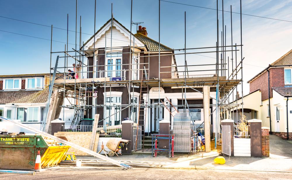 house with scaffolding around it indicating the construction of a home extension